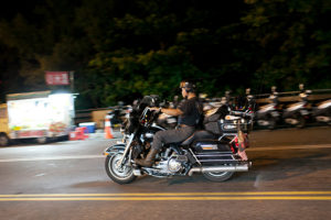Harley rider on the main road through Kending in the evening