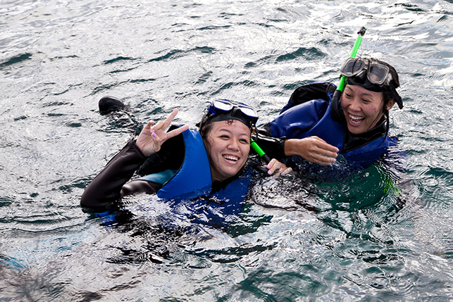 Two snorkelers in the water off the coast of Kending