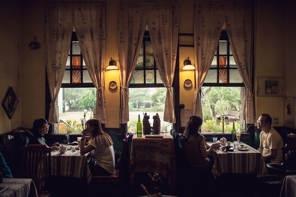 Diners chatting inside the Narrow Door cafe