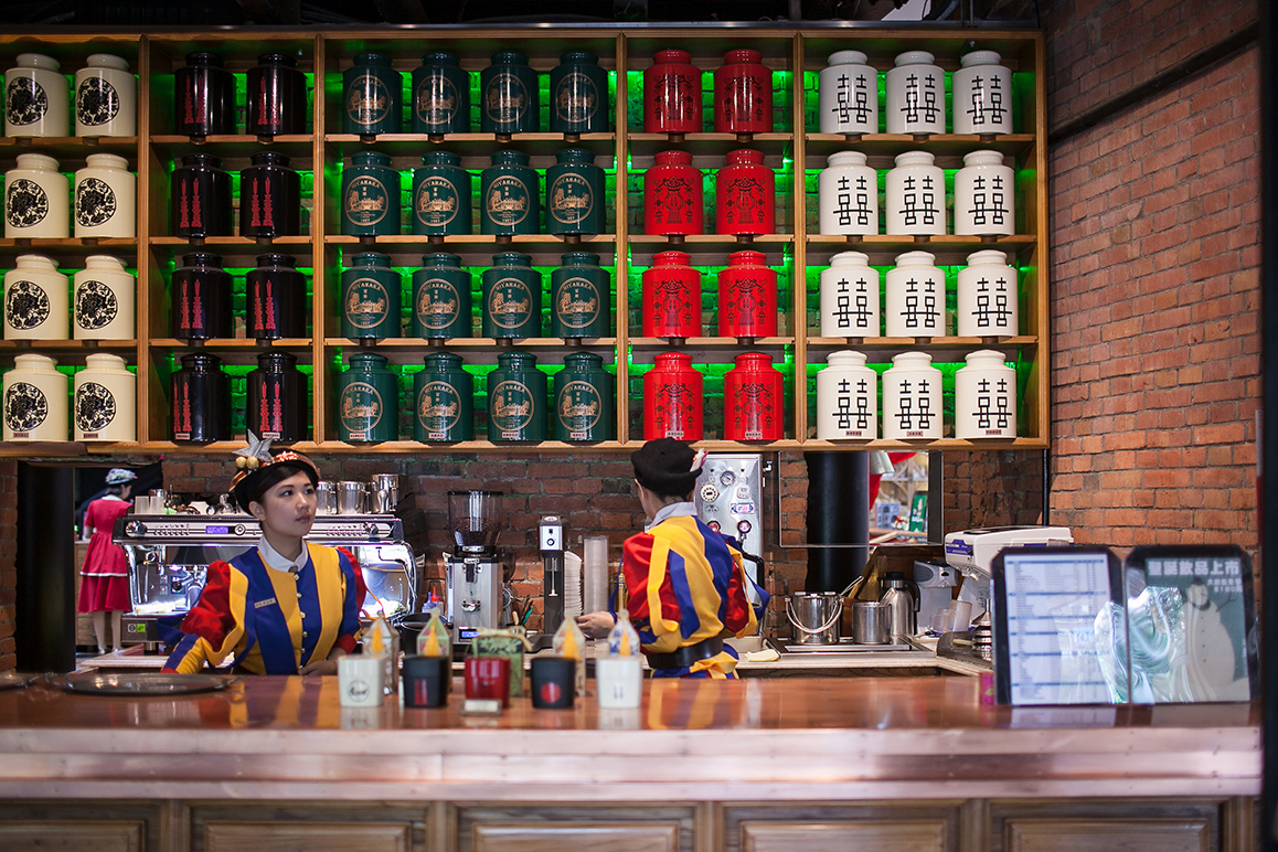 Two girls in colorful uniforms behind the counter of Miyahara