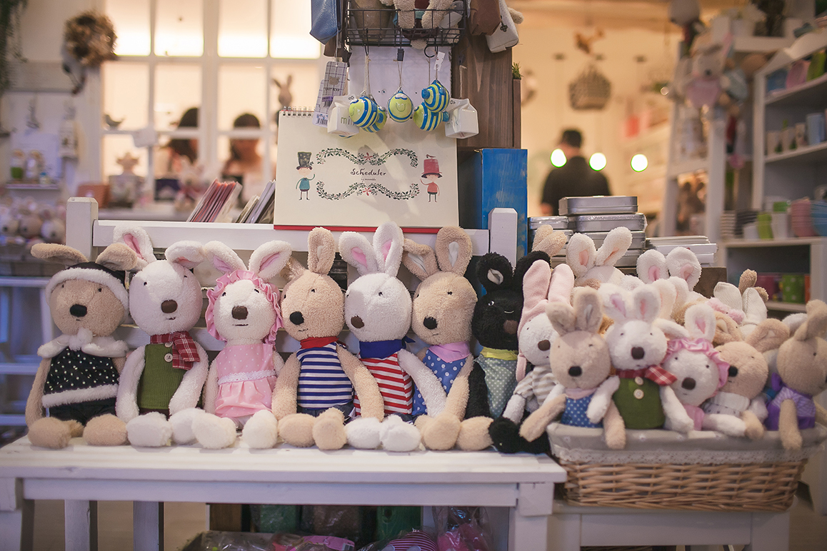 Cute stuffed animals sitting on a bench in Angel LaLa shop