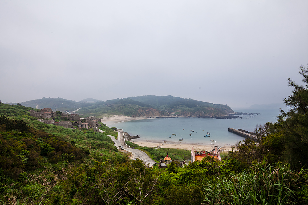 Distant look over Fuzheng Village, beach, and harbor