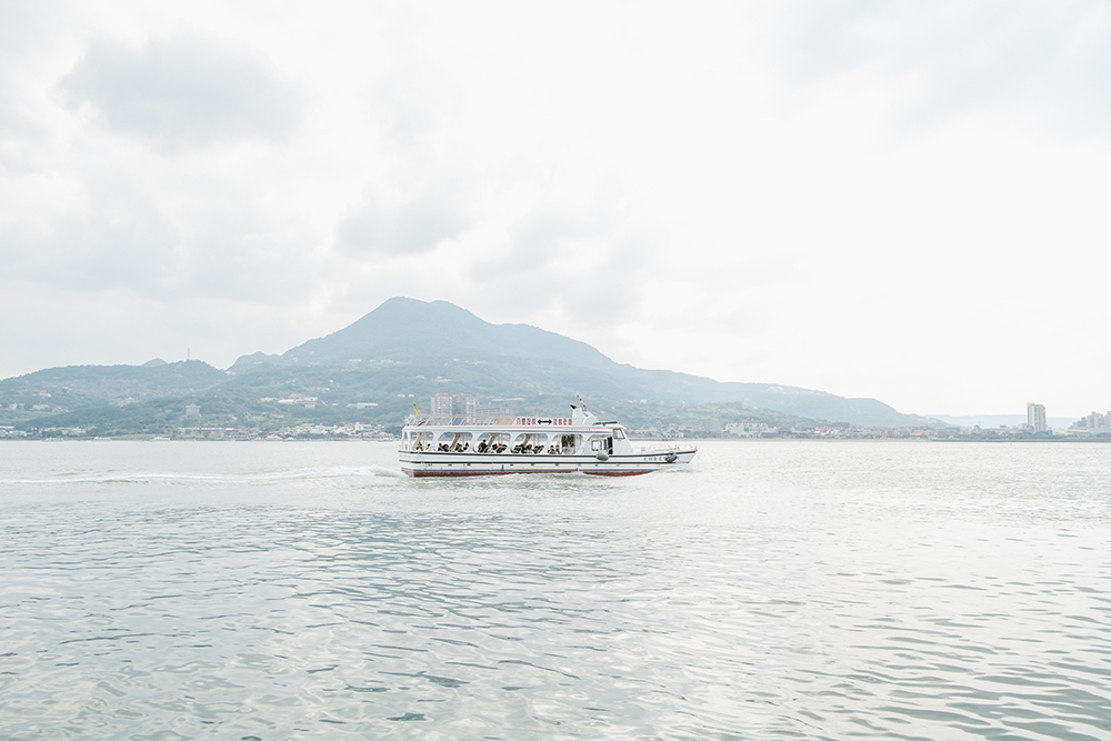Ferry on Tamsui River with Mt. Guanyin in the background