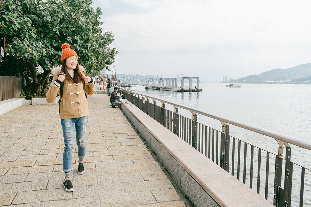 Girl walking along the river in Tamsui