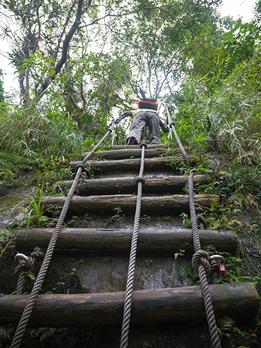 Steep wooden staircase above Pipa Cave Waterfall
