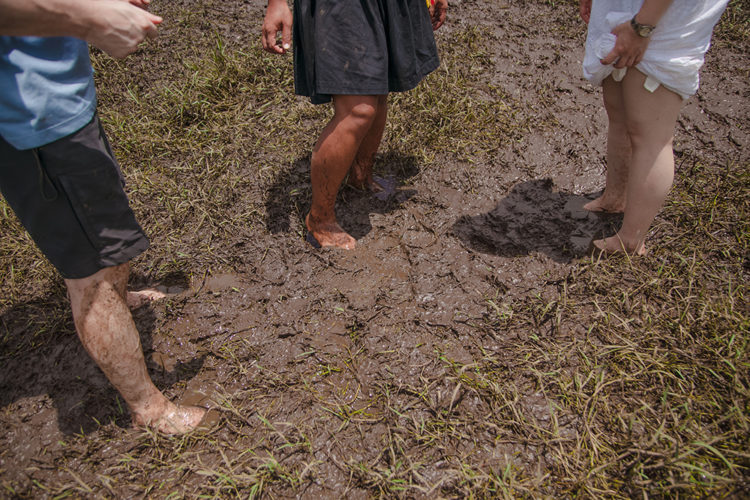 People exploring the muddy Dongyuan Wet Grassland