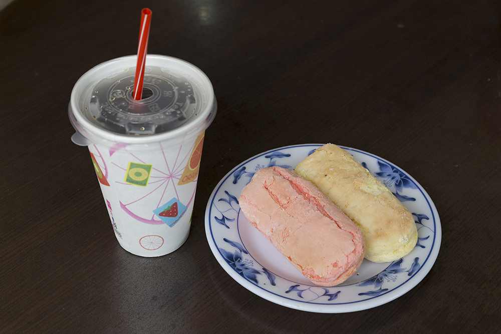 A cup of black tea and a plate with pastry