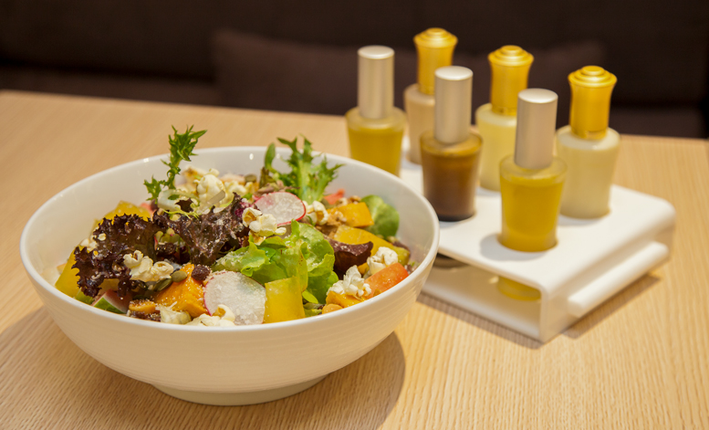Salad with vinaigrettes and creamy dressings in perfume spray bottles