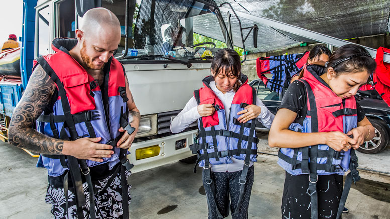 Putting on life vest before the rafting