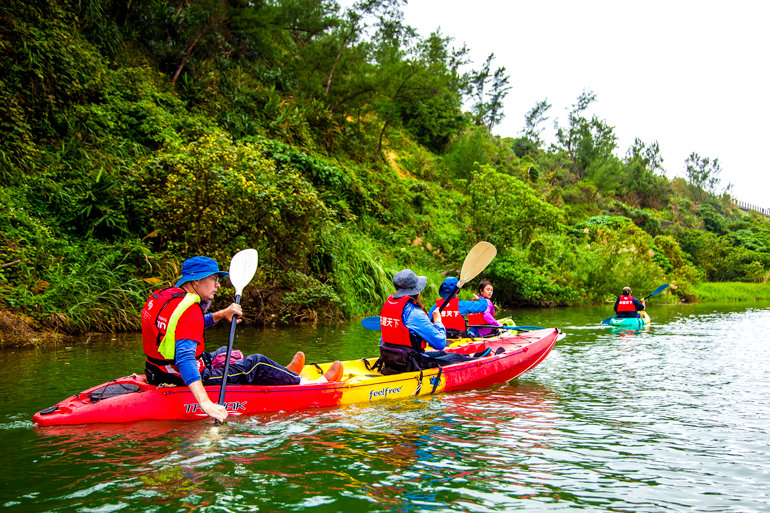 Paddling close to the river bank