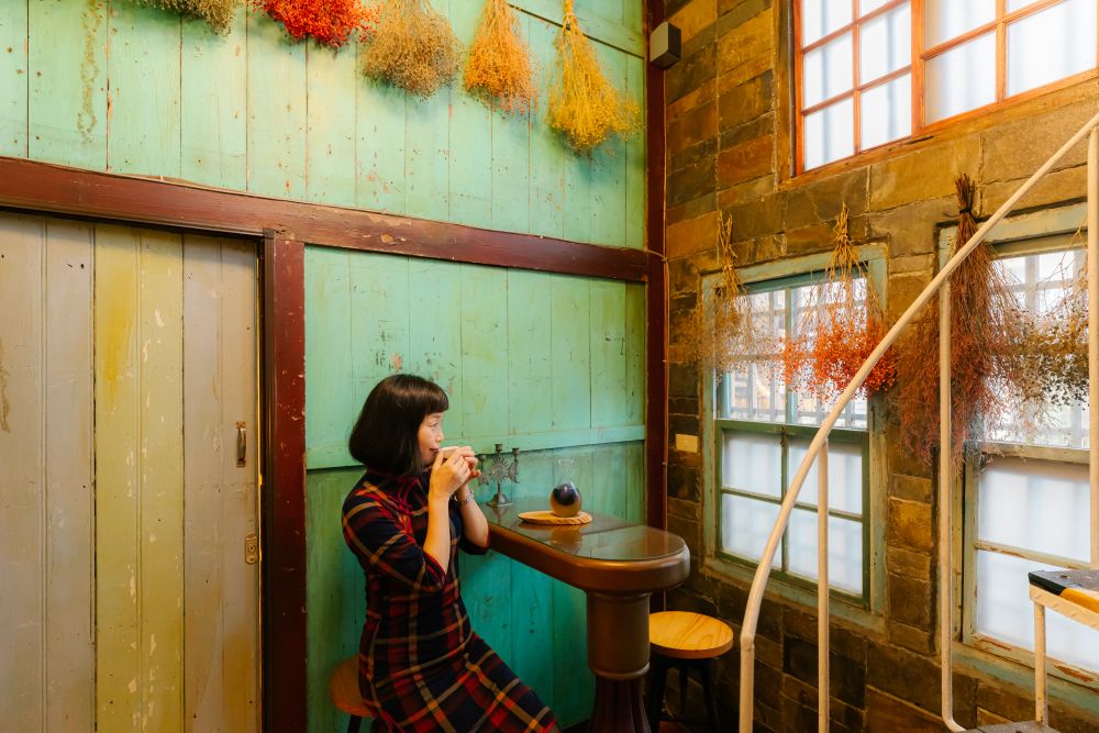 Sipping tea in a traditional qipao feels like stepping back in time